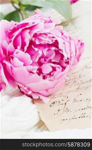 quill pen and antique letters. Pink peony with vintage letter on white lace background
