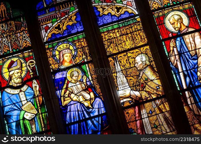 Quimper, Brittany, France - August 11 2017 : Stained glass in the Cathedral of Saint Corentin. Bishop his grace Graveran offering cathedral to Our Lady and St Corentin.. Stained glass in the Cathedral of Saint Corentin