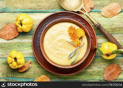 Quince puree or cream soup.Fruit soup on wooden table. Quince puree soup.