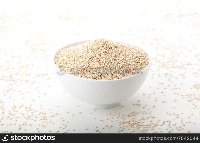 quinoa in white ceramic bowl on white background