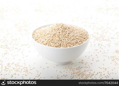 quinoa in white ceramic bowl on white background