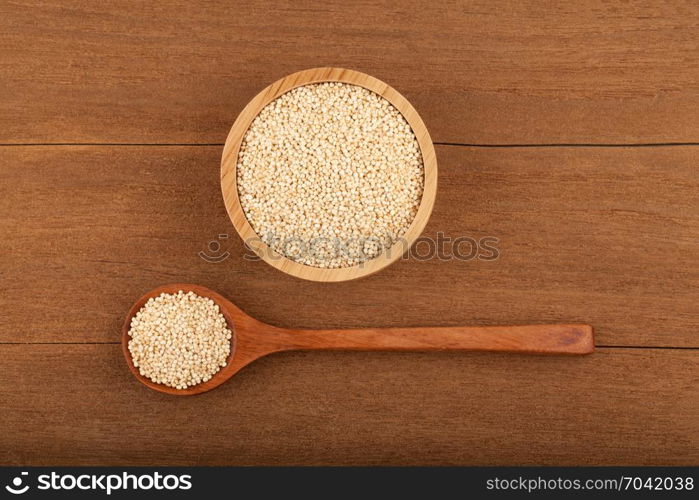 quinoa in wooden bowl on wood background