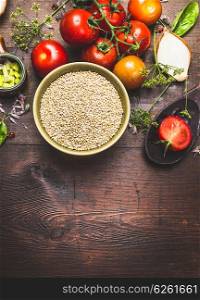 Quinoa salad preparation on dark wooden background, top view, place for text