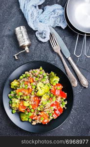 Quinoa salad with pepper, avocado , broccoli and oil . Vegan superfood