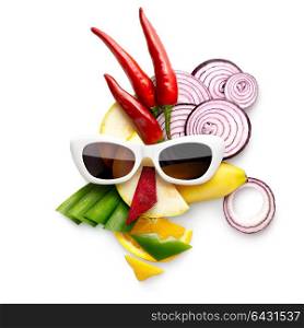Quirky food concept of cubist style female face in sunglasses made of fruits and vegetables, on white.