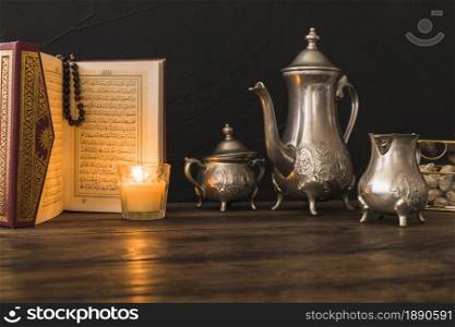 quran candle near tea set . Resolution and high quality beautiful photo. quran candle near tea set . High quality and resolution beautiful photo concept