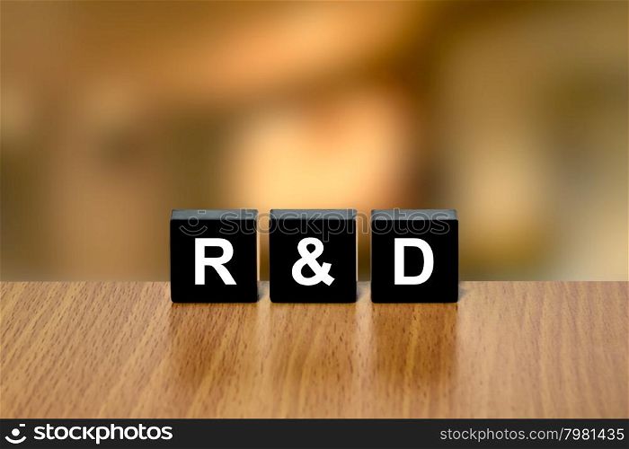 r&amp;d or Research and development on black block with blurred background