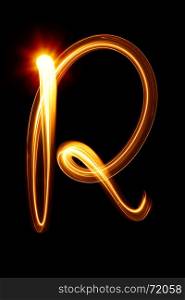 R - Created by light alphabet over black background