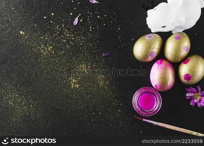 rabbit statuette paint near eggs