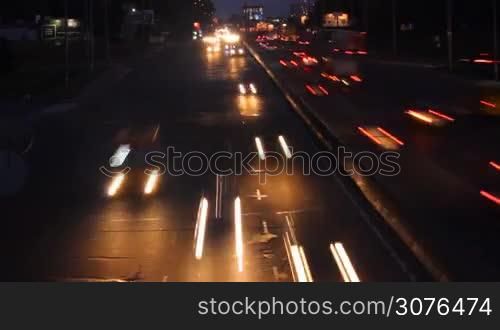 race cars on a wide avenue at night