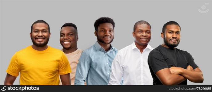 race, ethnicity and people concept - group of happy smiling young african american men over grey background. group of happy smiling african american men