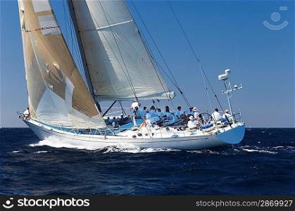 Racing Sailboat with Crew on Ocean