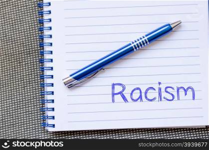 Racism text concept write on notebook with pen