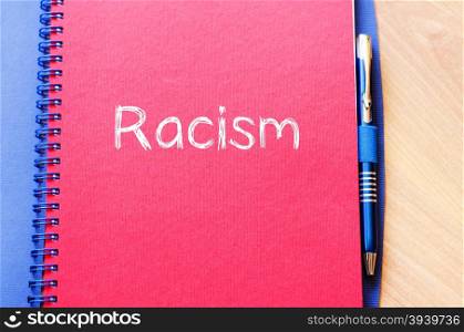 Racism text concept write on notebook with pen