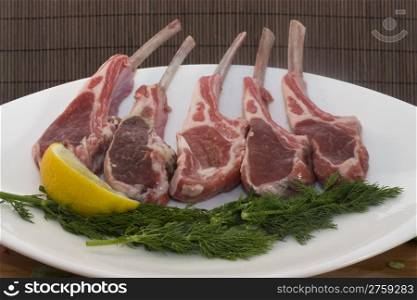 rack of lambs. a nice plate with some rack of lambs ready for cooking