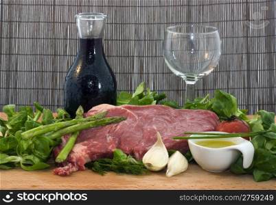 rack of lambs and other ingredients. a background food composition with beef wine and vegetables