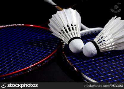 Racket and Shuttlecock with use sport or exercise on a black background.