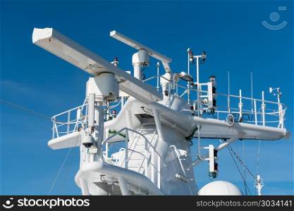 Radar antenna on the mast of a cruise ship. Navigation and radar equipment and antenna on the mast of cruise ship. Radar antenna on the mast of a cruise ship