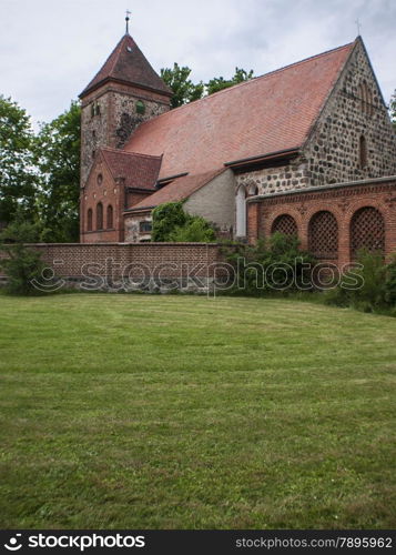 Radensleben-Dorfkirche-hoch. Radensleben is located along Route 164 (L164) between Wustrau and Herzberg north-west of Berlin. The place belongs since 1993 to Neuruppin - medieval village church with Campo Santo