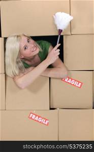 Radiant blonde amid cardboard boxes