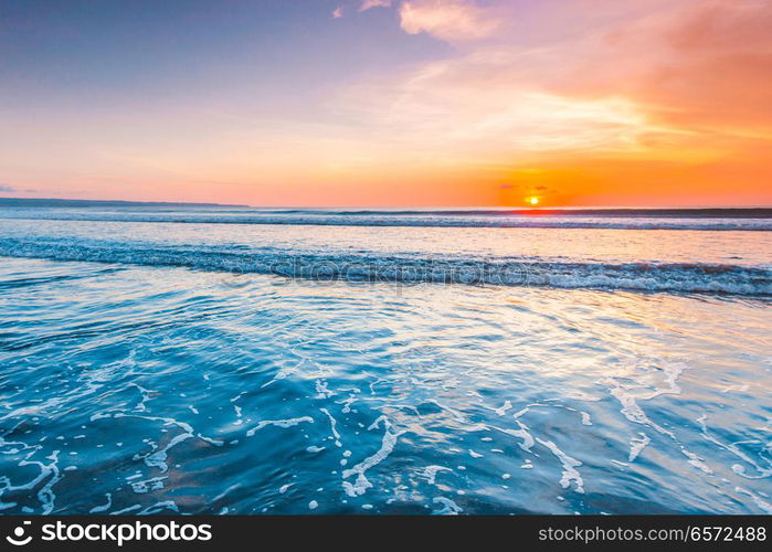 Radiant colorful sea beach sunset on Bali, Indonesia. Radiant sea beach sunset