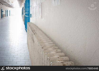 Radiator in an old prison. Metaphor of Heat in a cool place.