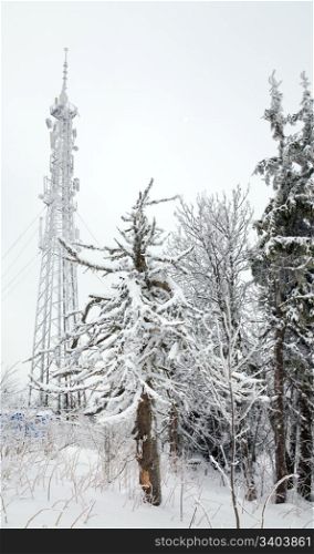 Radio -communication l tower on misty winter mountain peak