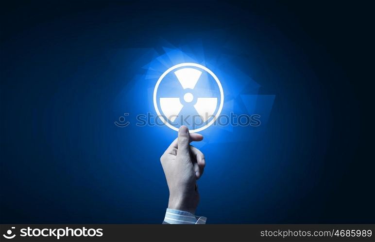 Radioactivity concept. Close up of human hand pushing application icon