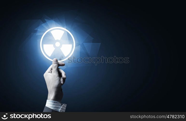 Radioactivity concept. Close up of human hand pushing application icon