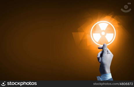 Radioactivity concept. Close up of human hand pushing application icon