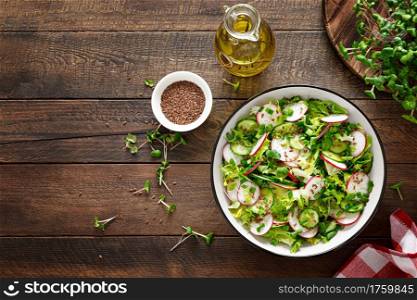 Radish and cucumber salad with fresh green onion in bowl