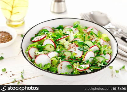 Radish and cucumber salad with lettuce and fresh green onion