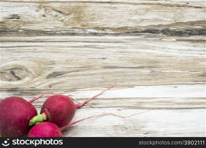 Radish on a wooden background. Rustic background.