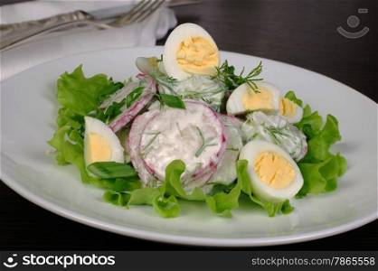 Radish salad with cucumber and quail eggs for milk sauce