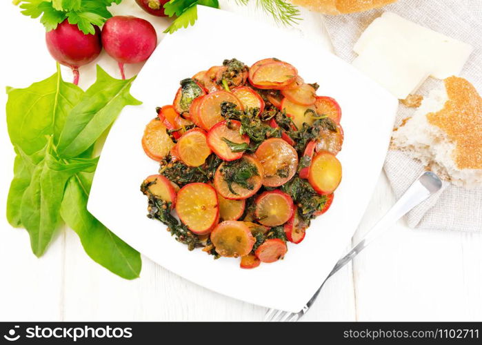 Radish stewed with spinach and spices in a plate, cheese and bread, napkin against light wooden board top