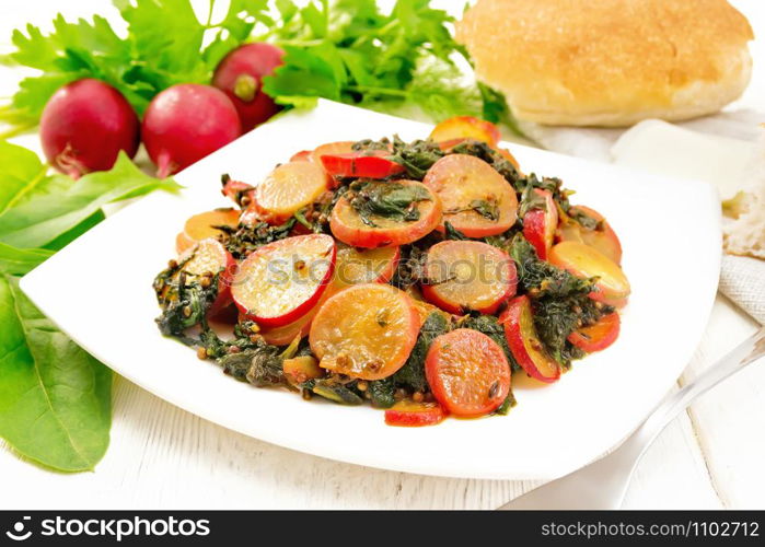 Radish stewed with spinach and spices in a plate, cheese and bread, napkin against wooden board background