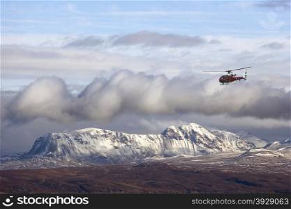 RAF helicopter and the Scottish Highlands viewed from the Isle of Skye, Scotland.