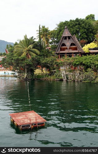 Raft and Samosir island on lake Toba, Indonesia