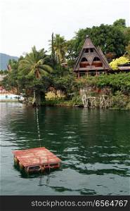 Raft and Samosir island on lake Toba, Indonesia