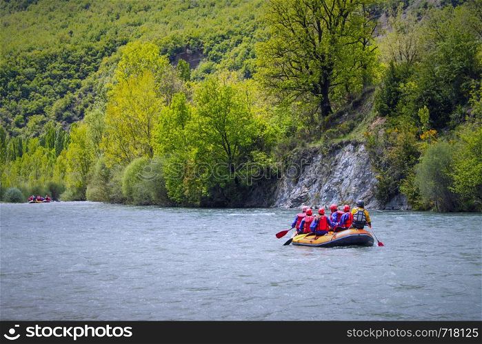 Rafting in a river of Huesca, Spain. Group of tourists in the inflatable raft