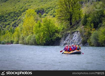 Rafting in a river of Huesca, Spain. Group of tourists in the inflatable raft