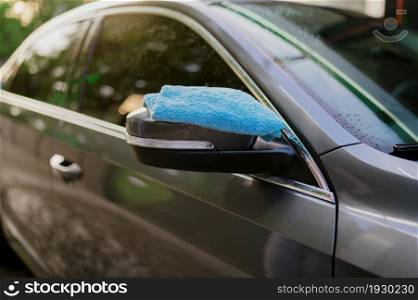 Rag on the rearview mirror, hand car wash station, nobody. Car-wash industry, carwash business concept. Clean auto exterior. Rag on the rearview mirror, hand car wash station