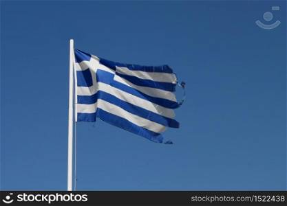 Ragged flag of Greece waving in wind horizontal. Ragged Greek flag
