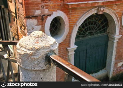 Railings of the old bridge over a canal in Venice, Italy