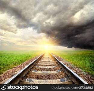 Railroad and clouds in the field at sunrise