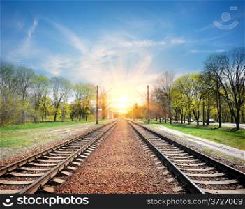 Railroad at sunrise in sunny spring day