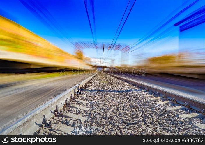 Railroad in motion. Railway station with motion blur effect