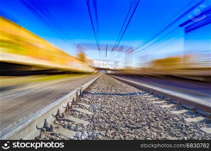 Railroad in motion. Railway station with motion blur effect