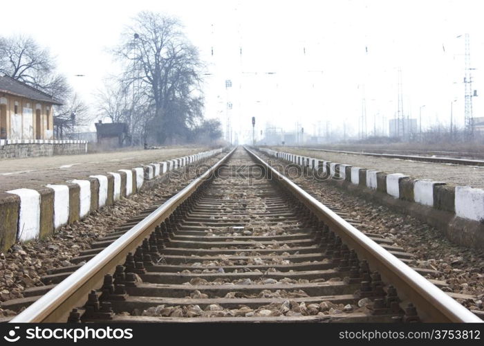 Railroad metal train tracks shot at perspective view.