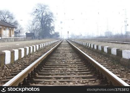 Railroad metal train tracks shot at perspective view.